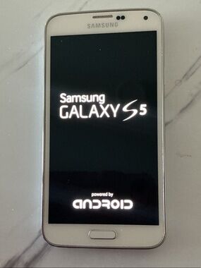 Samsung Galaxy S5 White Cell with 2 Cases Included. Barely used.